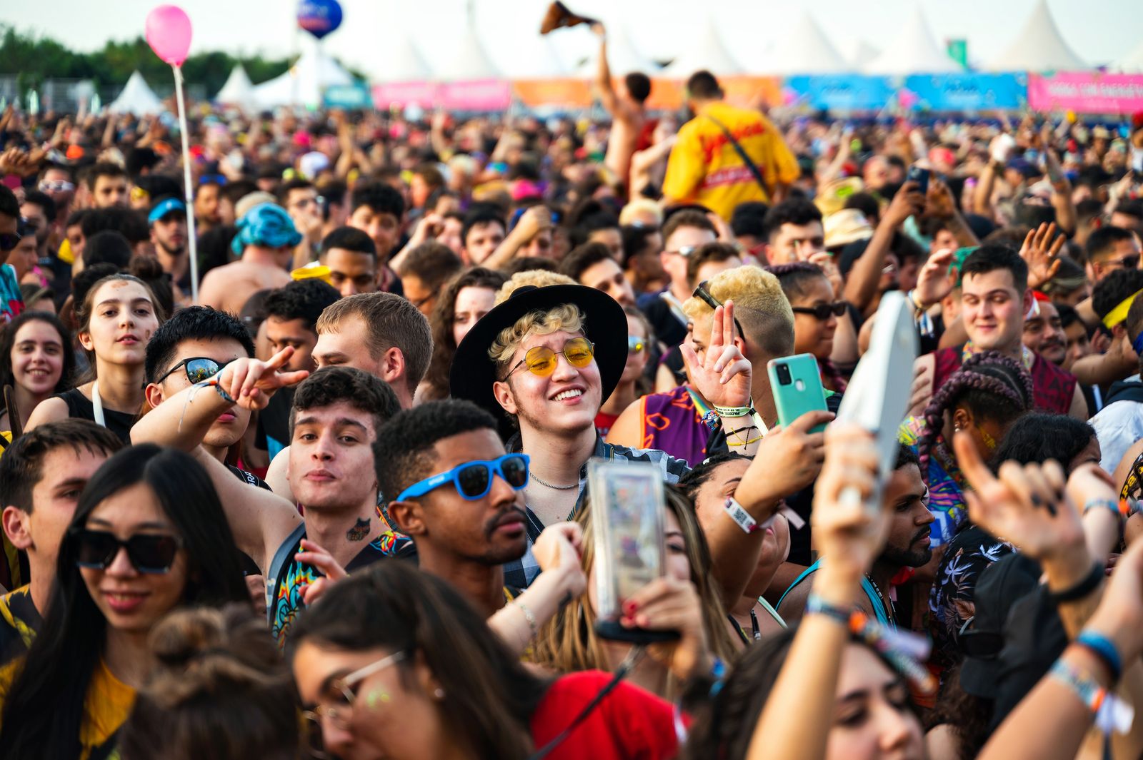 A diverse crowd enjoying an outdoor music festival