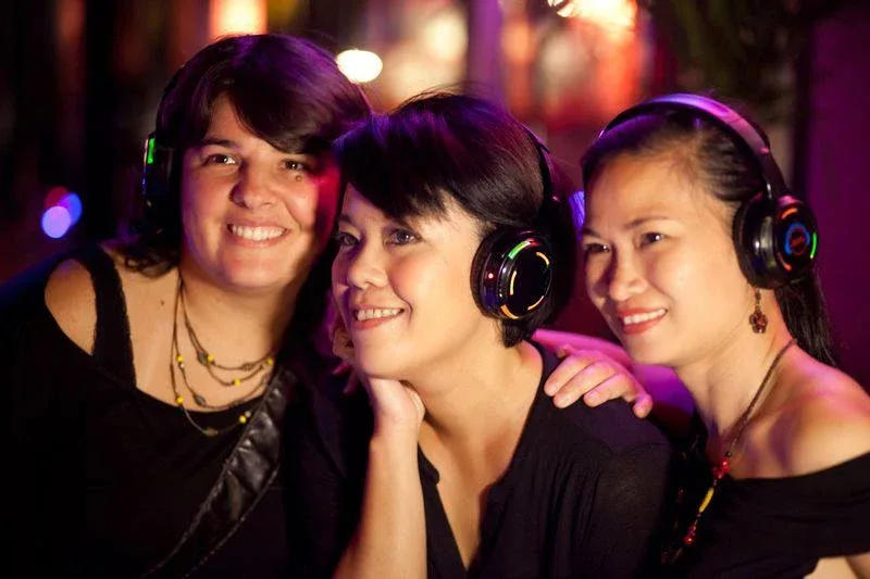 Guests smiling with headphones at the Latino Party