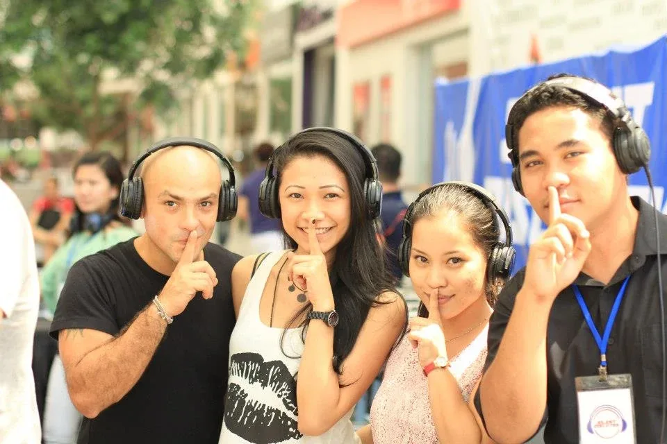 A group of visitors wearing headphones at the Taylor’s preview