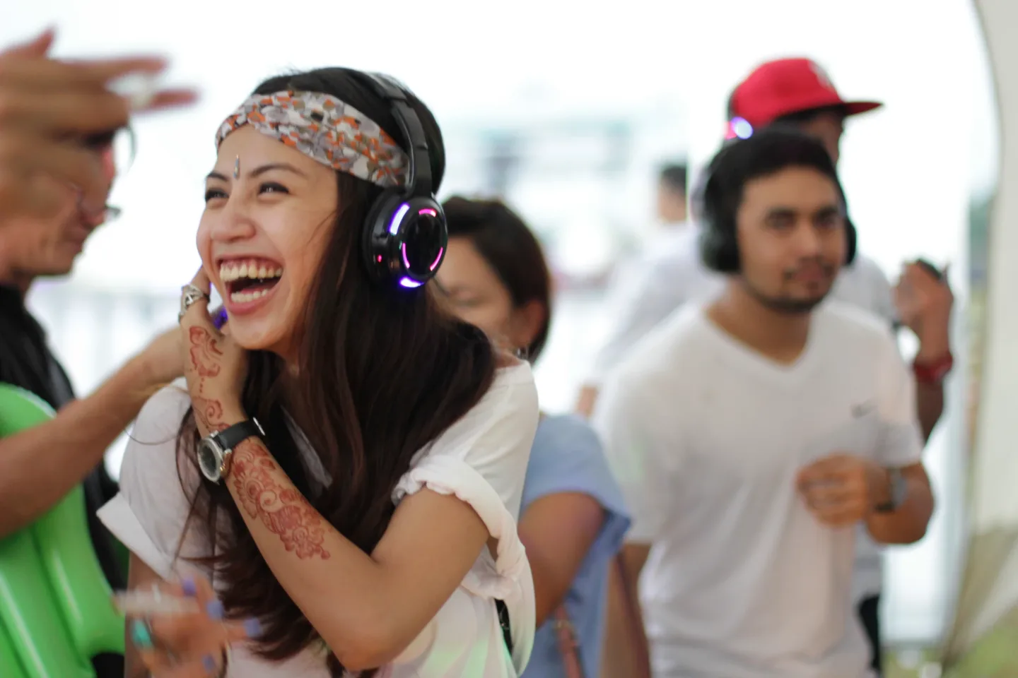 A guest celebrating with headphones at Good Vibes Festival