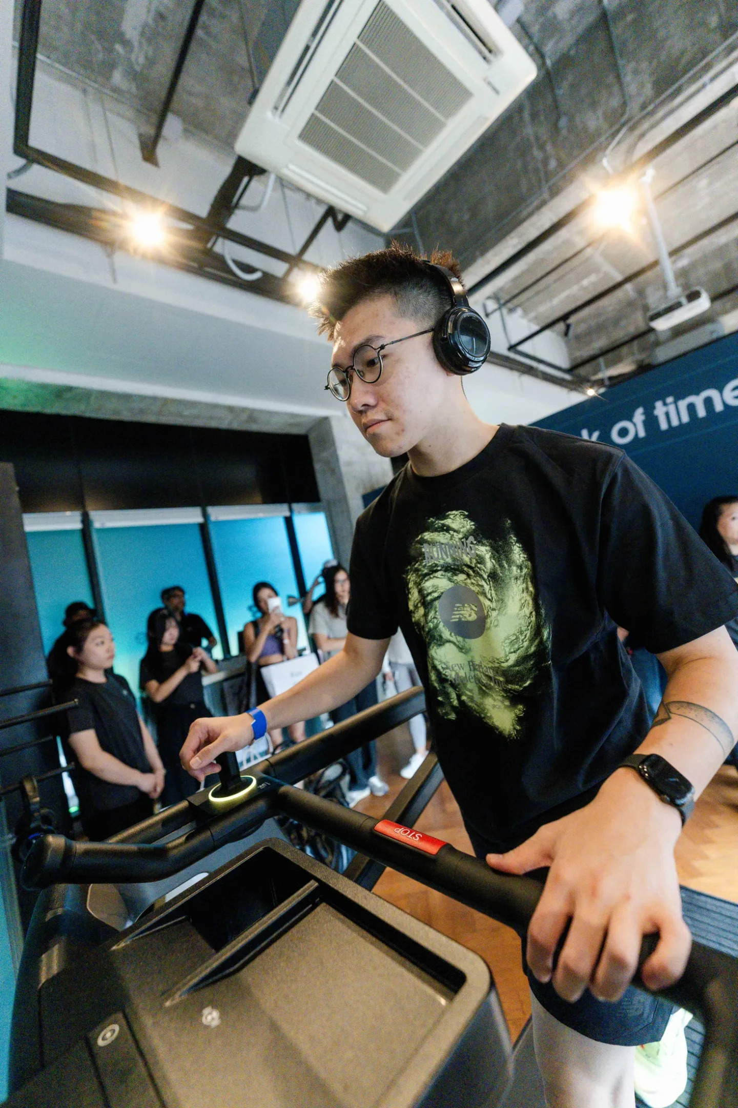 Guest wearing wireless headphones at the New Balance Ellipse fitness corner