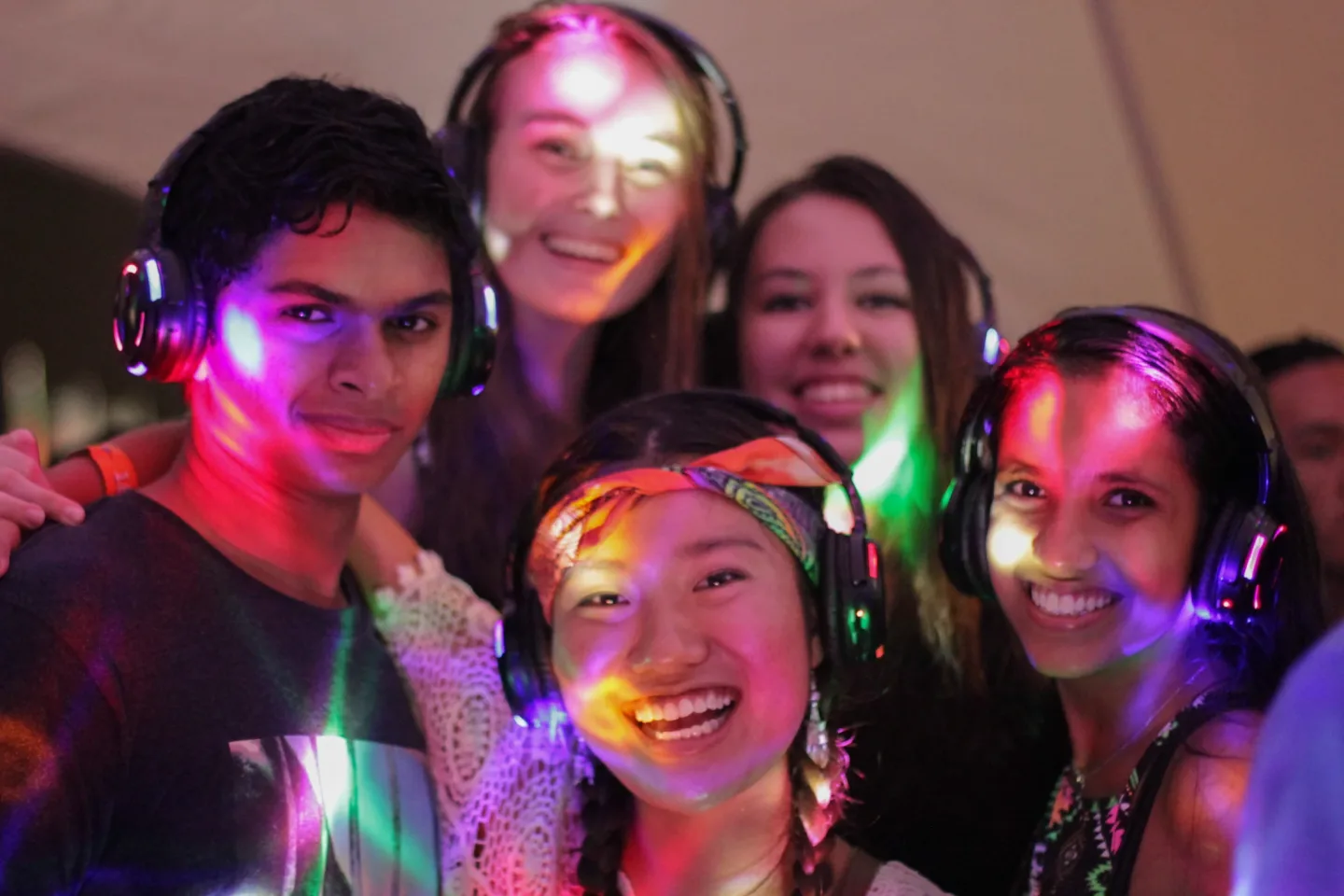 Friends wearing illuminated headphones at Good Vibes Festival