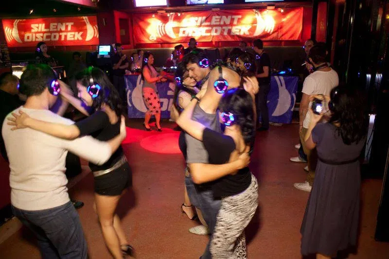 Couples dancing in wireless headphones