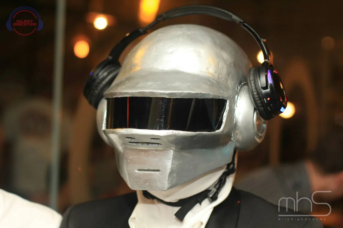 A helmeted guest listening through headphones at the Random Access Memories album launch