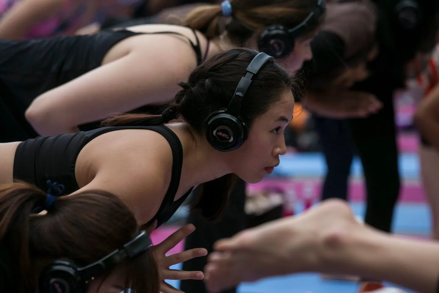 A yoga participant wearing wireless headphones