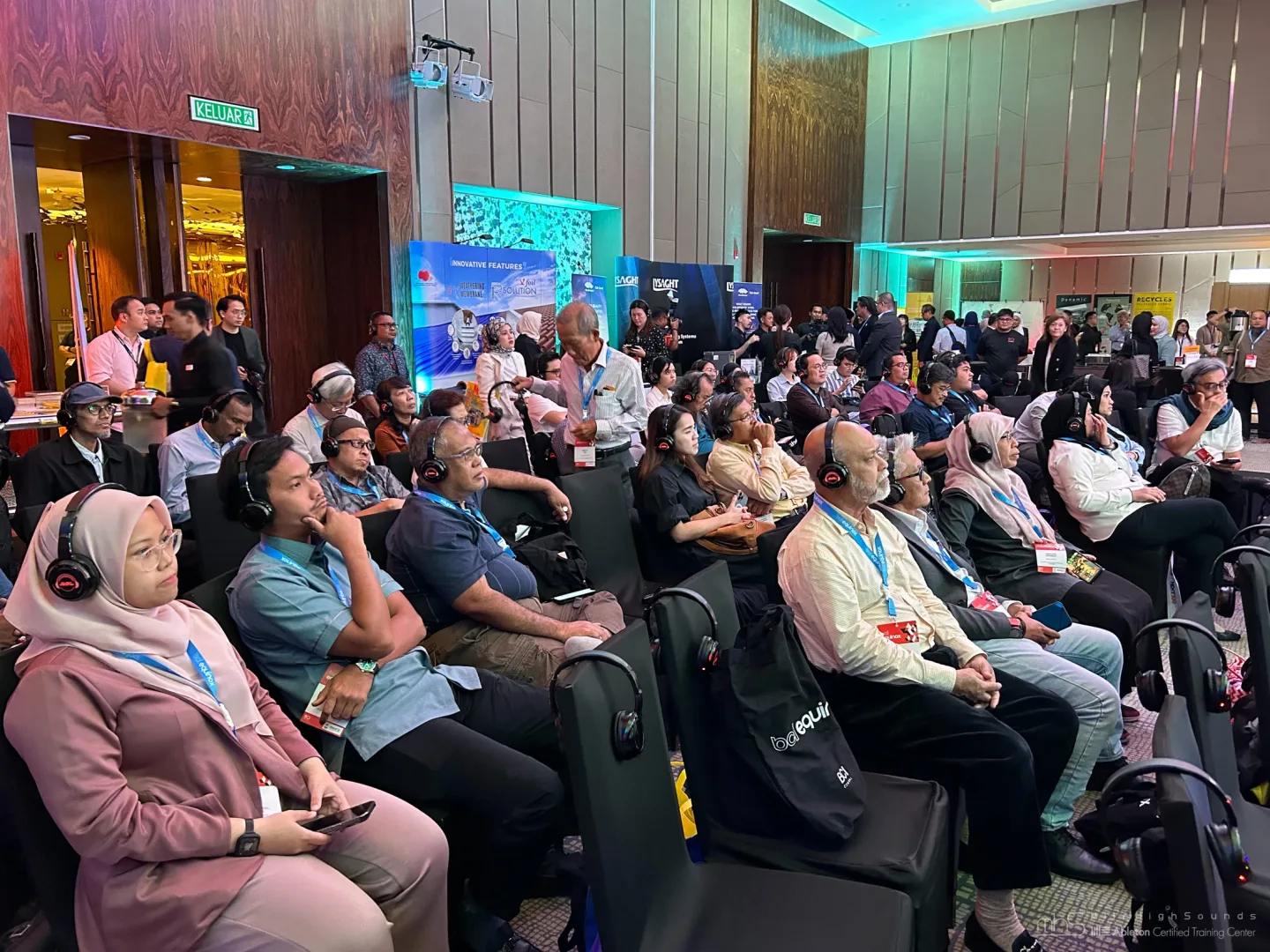 Audience members wearing wireless headphones at the BCI Asia / Hubexo Johor conference