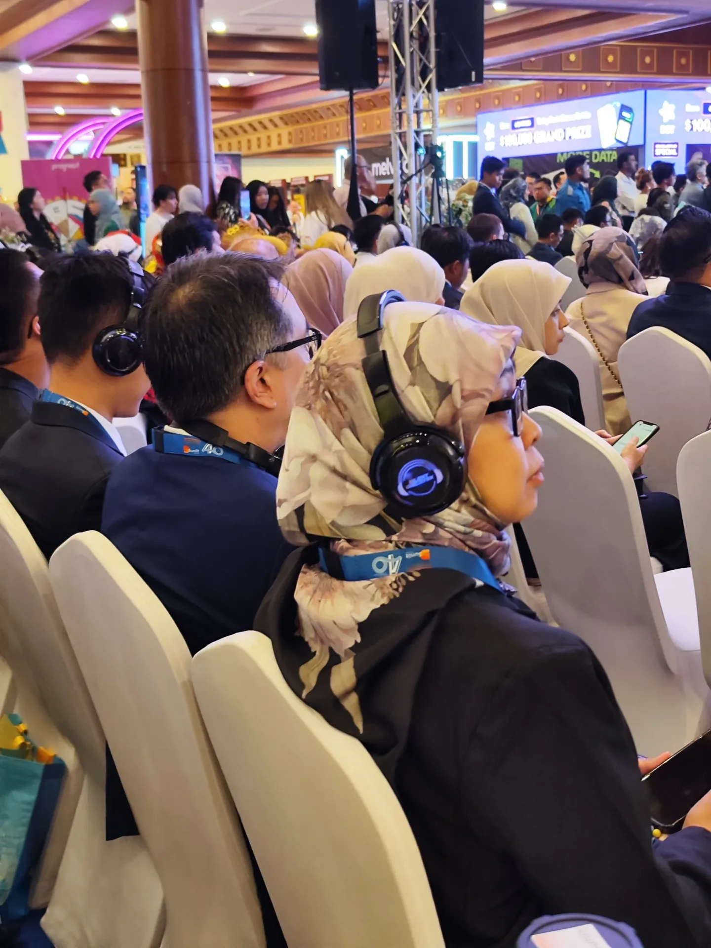 A conference attendee listening through Silent Discotek wireless headphones