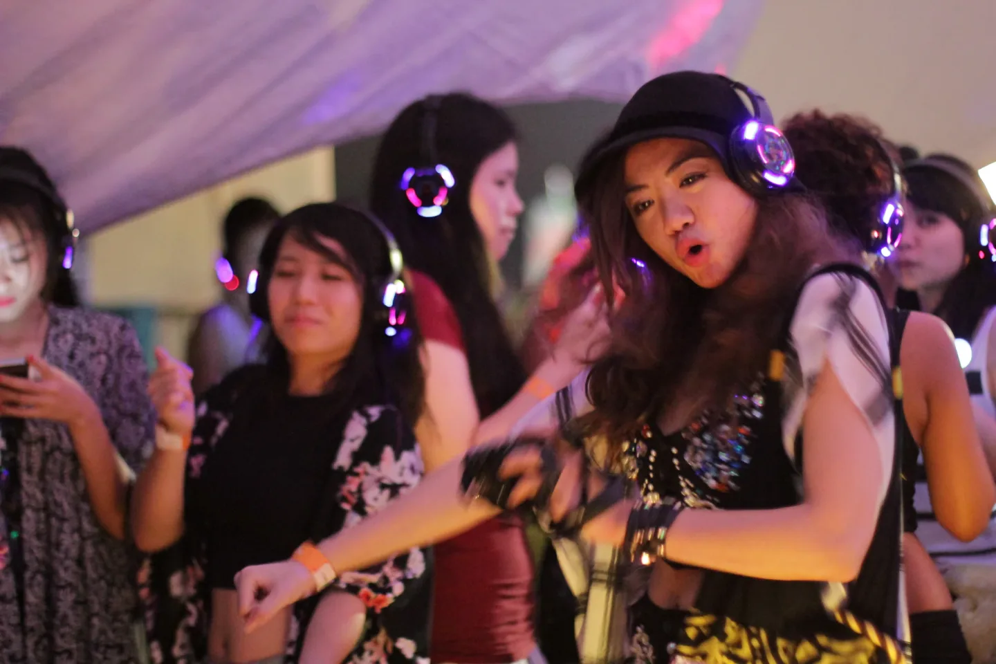 A guest dancing in the Silent Discotek festival area