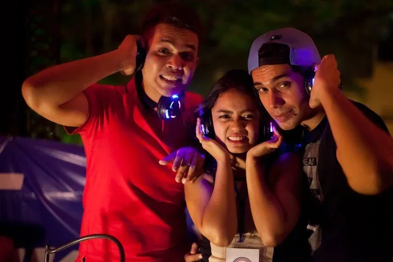 Friends enjoying wireless headphones at the Silent Discotek Preview Party