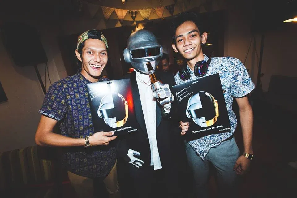 Guests posing with helmets at the Wondamamma listening event