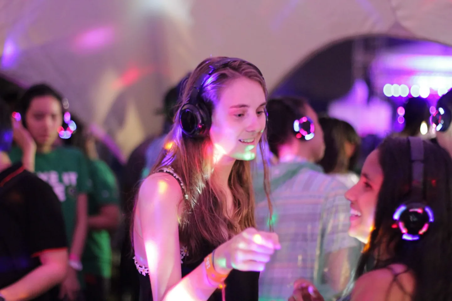 Guests dancing in wireless headphones at Good Vibes Festival