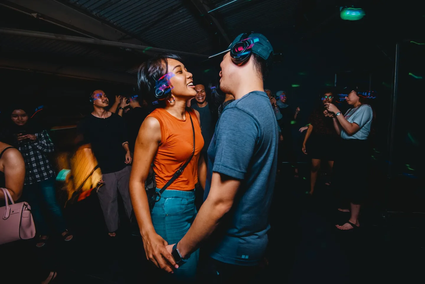 Two guests dancing together in headphones at RIUH