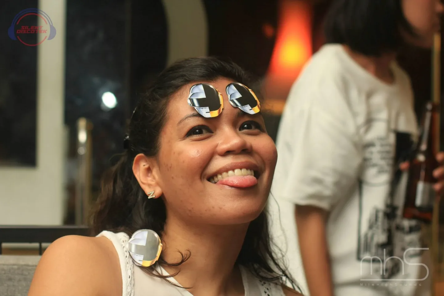 A smiling guest trying the listening system at the Livescape event
