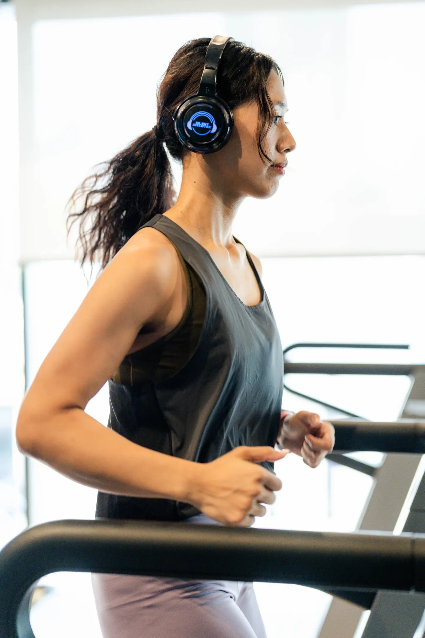 Participant running with Silent Discotek headphones during the New Balance Ellipse workout challenge