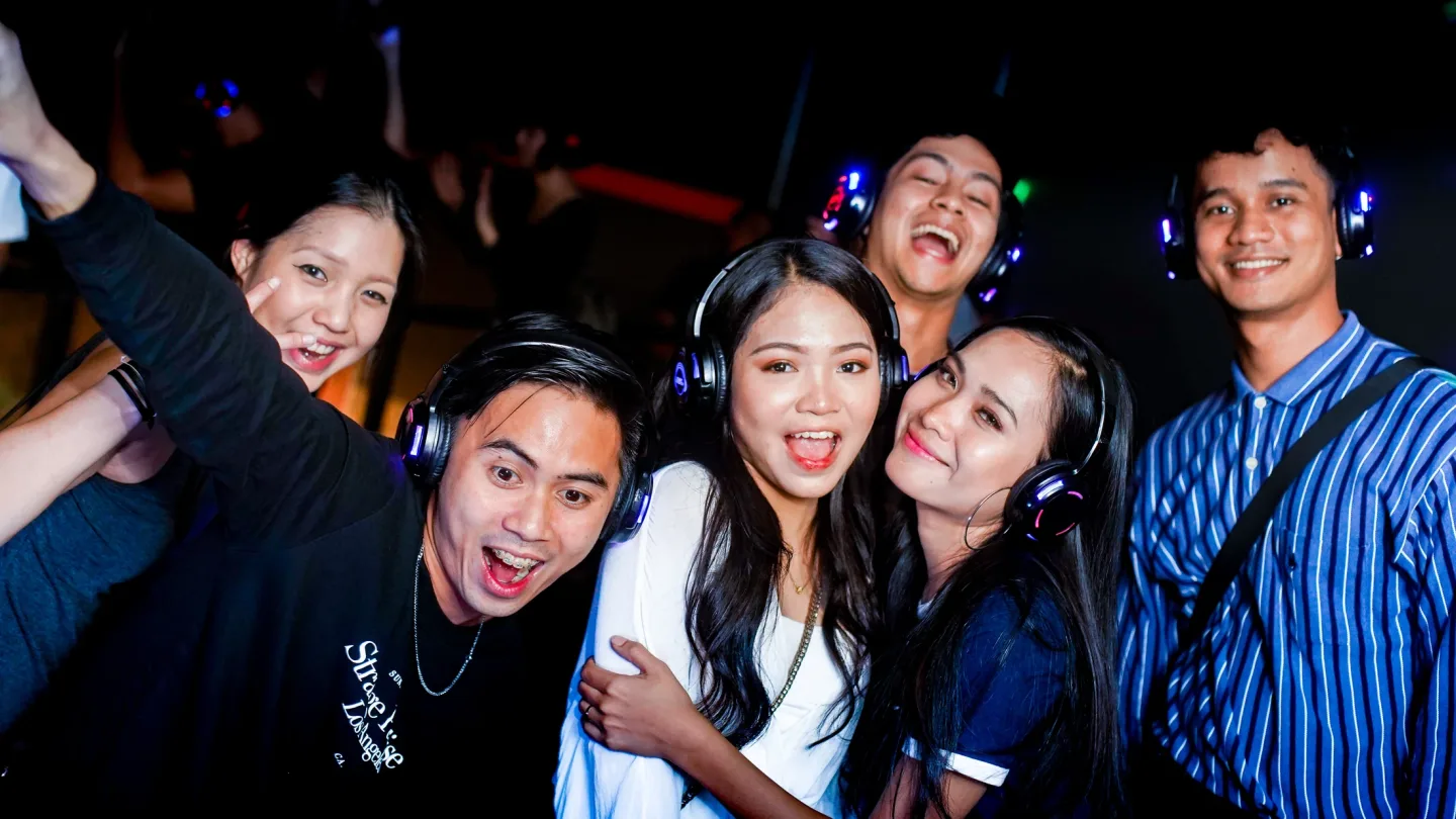 A group of friends wearing headphones at RIUH
