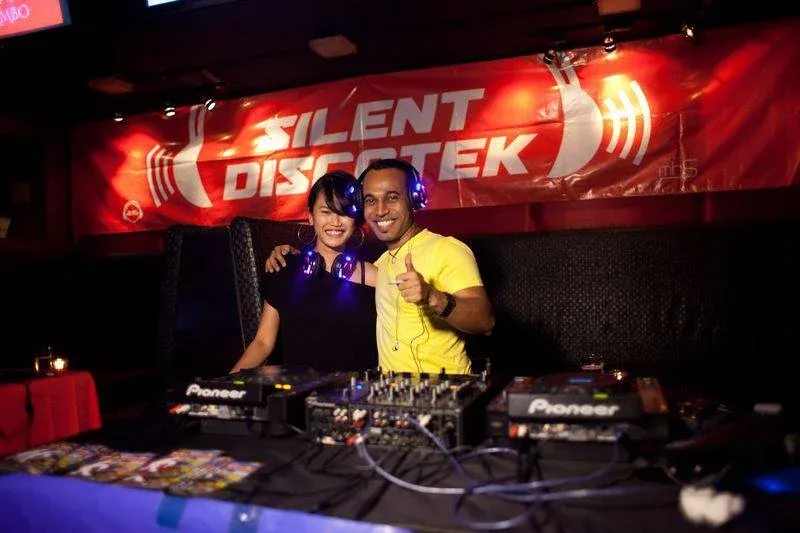 DJ and dancers at the Silent Discotek Latino Party