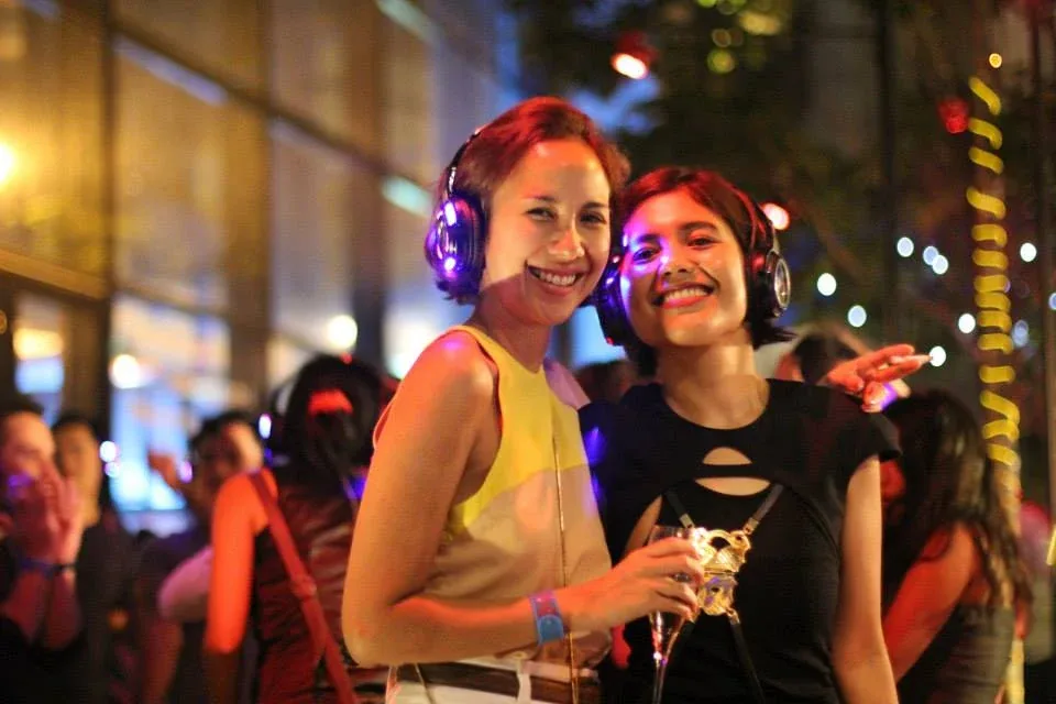 Two guests smiling at the Merdeka Eve party