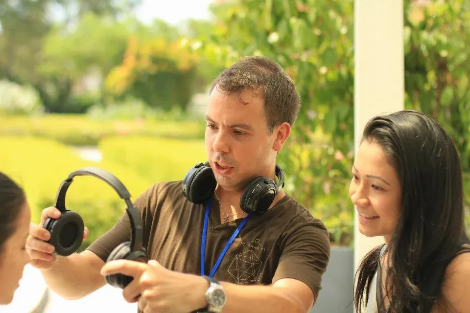 A guest being introduced to the wireless headphones