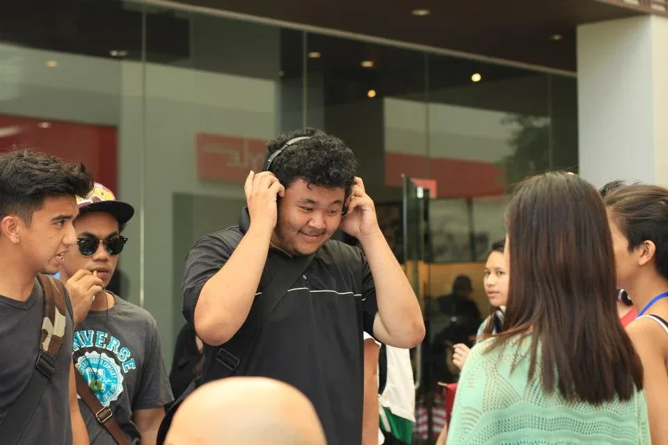 A visitor listening through the headphones outdoors