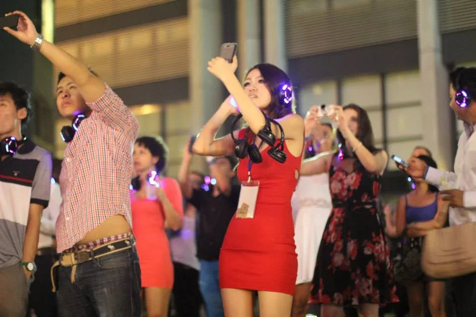 Two guests dancing together while wearing headphones