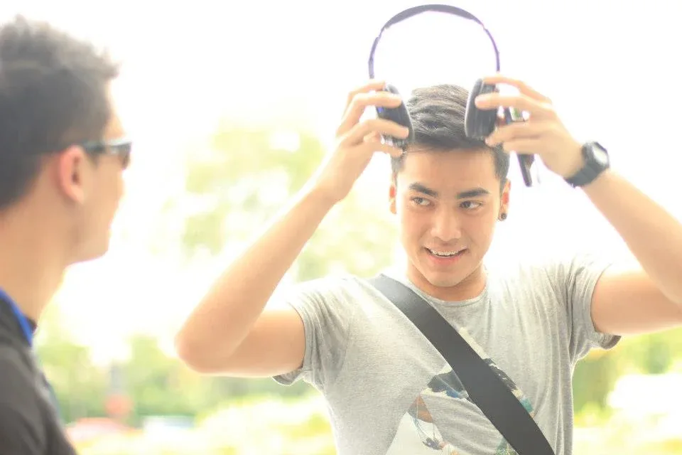 A campus visitor putting on the headphones