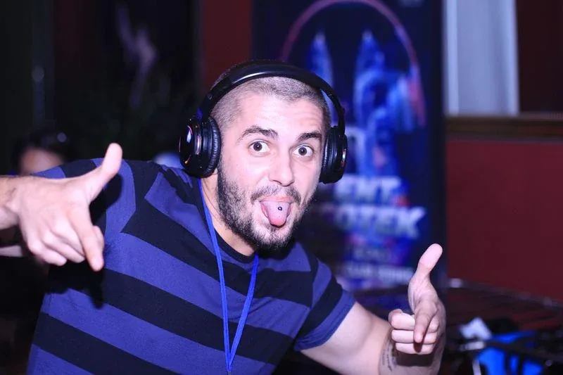 A guest dancing and smiling in headphones at Havana