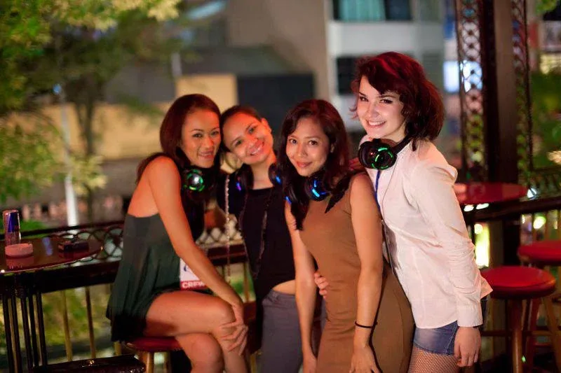 Friends wearing wireless headphones at the Latino Party