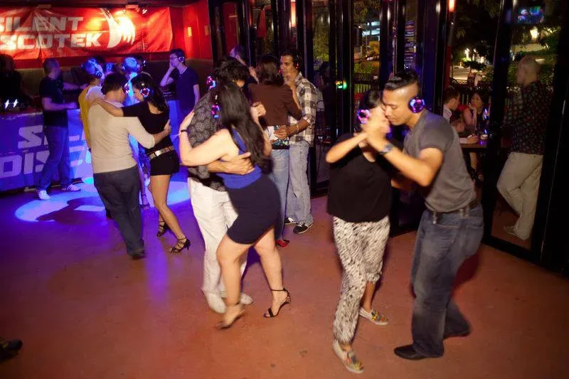 Two guests enjoying the headphone dance floor