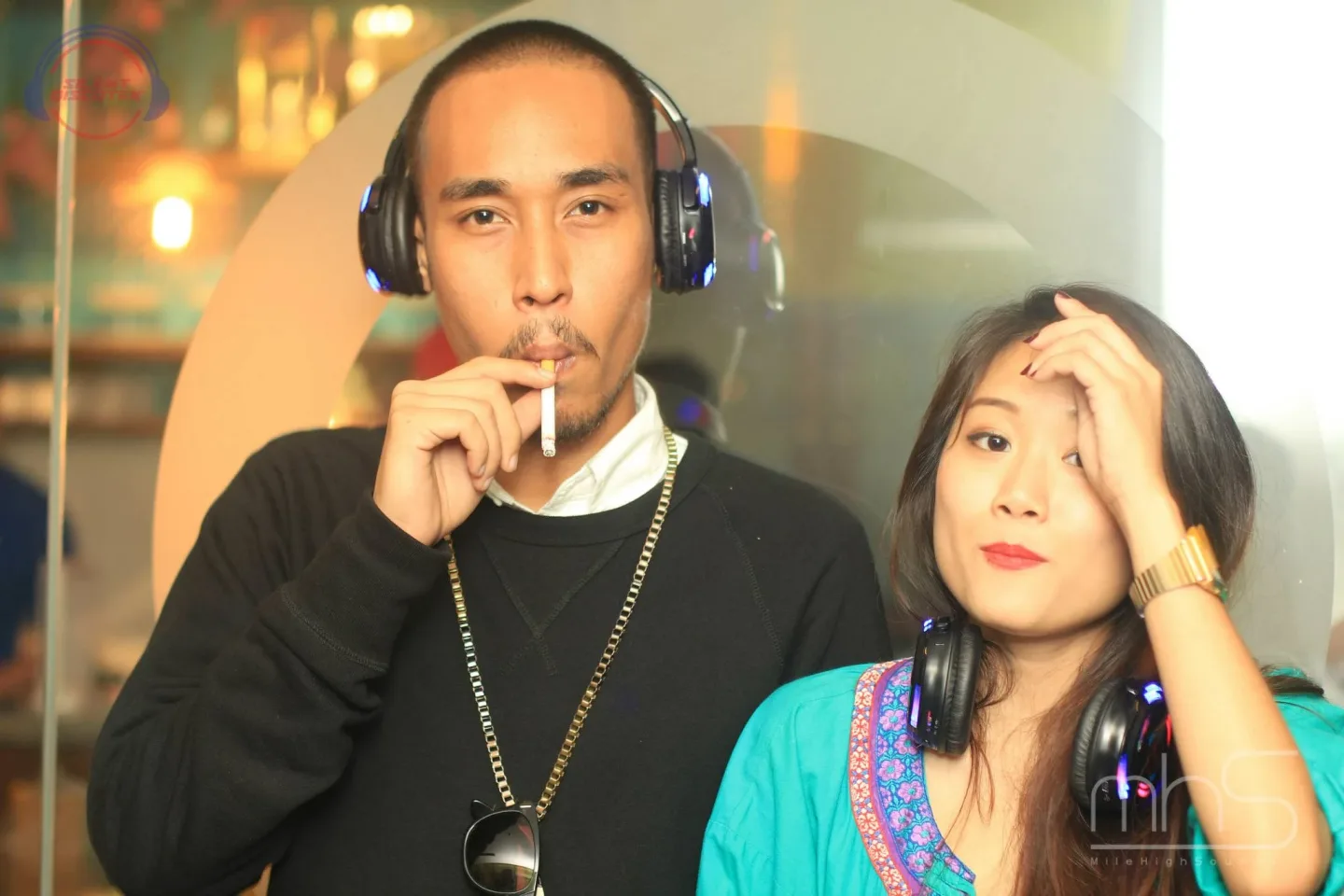Two guests listening through wireless headphones at the Livescape album event