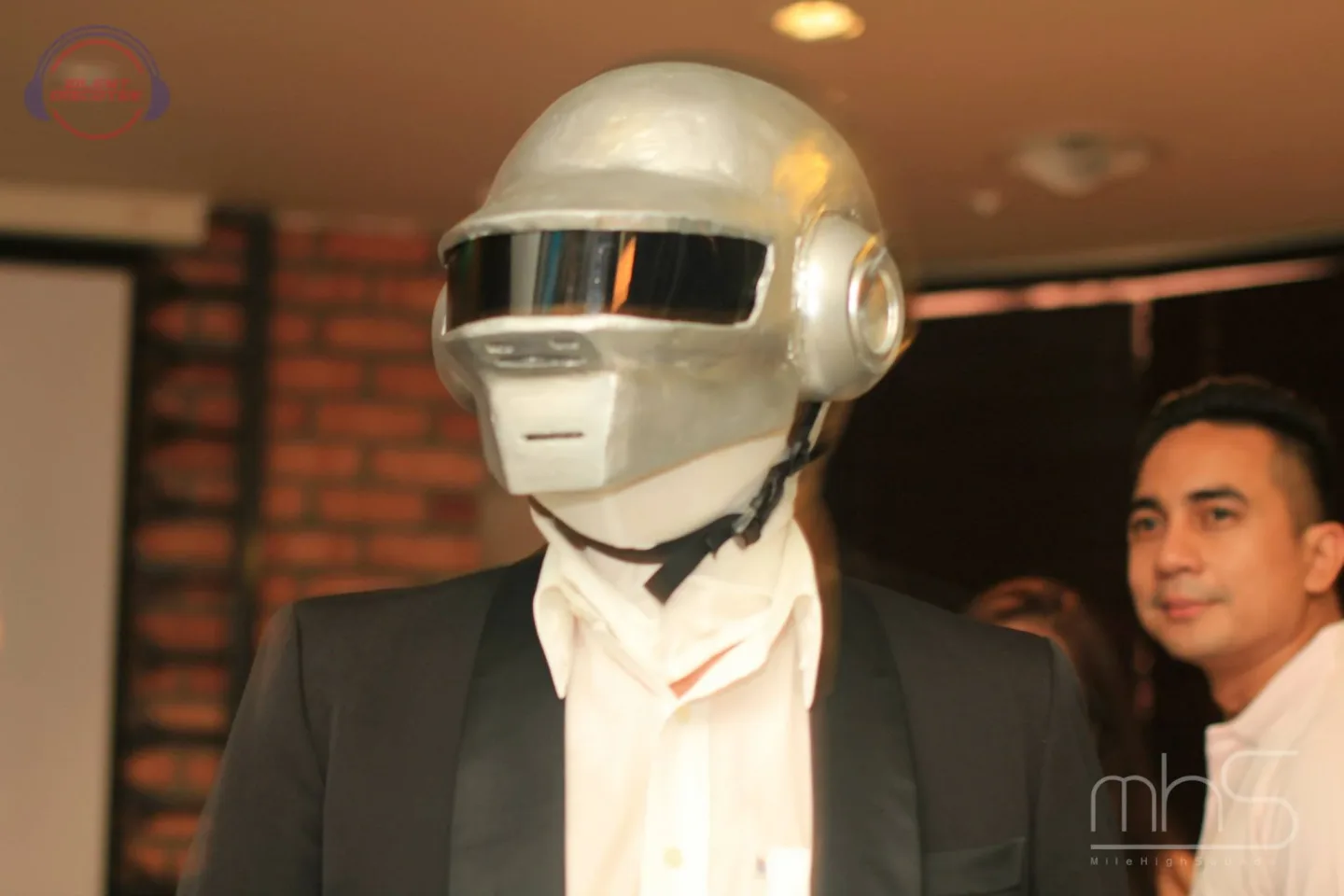 A guest wearing a silver helmet and headphones at the Livescape event